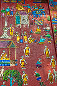 Wat Xieng Thong temple in Luang Prabang, Laos.  La Chapelle Rouge , the Red Chapel. The exterior walls are decorated with colourful mosaics on a pink background with scenes of people daily activities. South wall. 